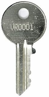 Close-up of a silver replacement key with a circular head and a cut blade.