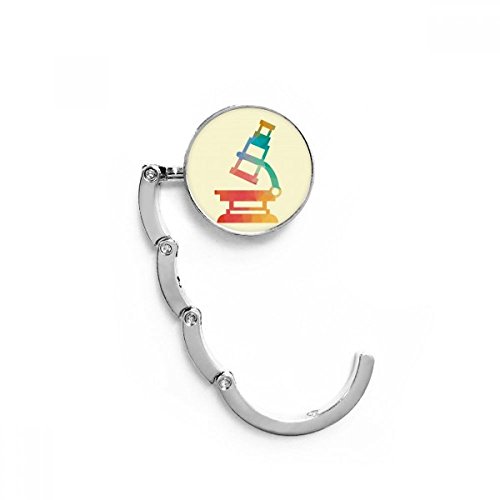 Gancho plegable para bolso que evita el suelo sucio con diseño de microscopio