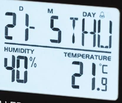 Close-up of the Atlanta 1869 alarm clock's main display showing humidity and temperature readings