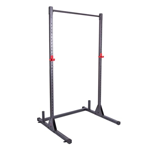 CAP Barbell Power Rack in matte black powder coat on rubber gym flooring in a converted basement, the four uprights extending to 85 inches with 11/12 gauge steel construction visible at the welds, the J-cup catches set at chest height for a bench press setup, an Olympic barbell racked in the catches with 25 lb plates loaded on each side, the built-in pull-up bar visible at the top crossbeam, the weight-storage posts extending from the rear uprights -- the documented base of countless under-$300 garage builds in r/HomeGymUK and the staple first-power-rack pick across BarBend and Garage Gym Reviews budget guides.