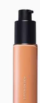 MAKE Beauty Diffusion Dew Skin Tint. Sheer to Medium Coverage Radiant Finish. Blurring, Smoothing, and Brightening for Glowing Complexion. Enhanced with Niacinamide and Adenosine. Suede 12