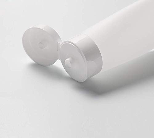 Close-up of the flip cap mechanism on a clear plastic squeeze tube, showing the cap in a closed position.