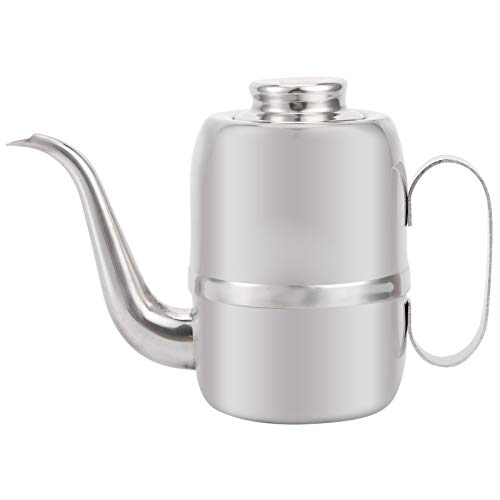 Botella de aceite de acero inoxidable para aliñar ensaladas en la mesa familiar