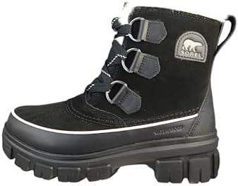 Woman confidently walking through urban snow wearing Sorel Women's Torino boots.