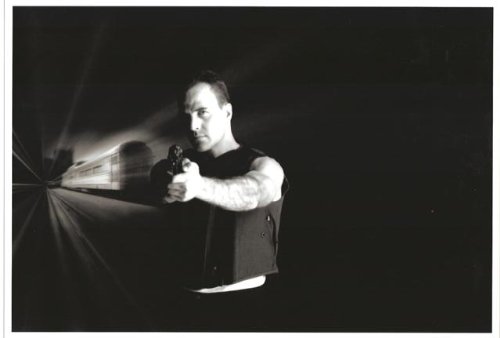 Richard Burgias Jim Ellison in The Sentinel holding gun with train behind him black and white 8 x 10 photo