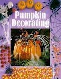 A cover of Pumpkin Decorating by Vicki Rhodes. There is a photo of a carved pumpkin surrounded by Halloween and decor on a purple background.