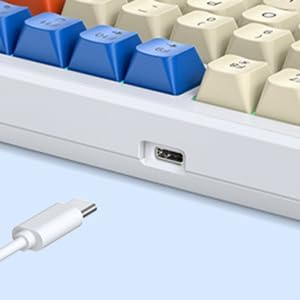 USB-C port on the side of the keyboard with a white USB-C cable plugged in.