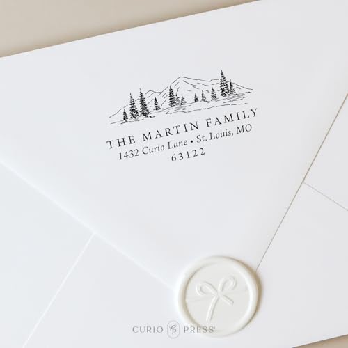 rubber stamp printed with a family name and cabin design