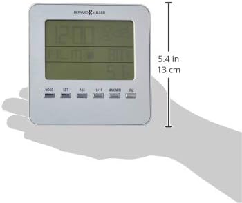 Howard Miller 645-693 Weather View Alarm Clock held in a hand, showing its width