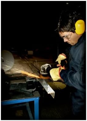Worker wearing safety glasses and hearing protection, operating a disc grinder on a metal workpiece, producing sparks.