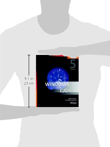 Side view of Windows via C/C++ book held by hands, showing its dimensions of 9.1 inches (23 cm) in height.