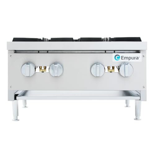 Chef adjusting individual control knobs on Empura hot plate range.