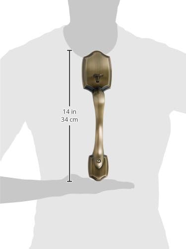 A Kwikset handleset held by a person, with measurements indicating a length of 14 inches or 34 cm.