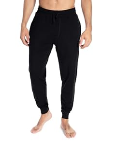 Bottom half of a man in black jogger sweatpants.