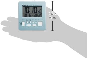 Hand holding the Casio DQD-805J-2JF alarm clock, showing its compact size