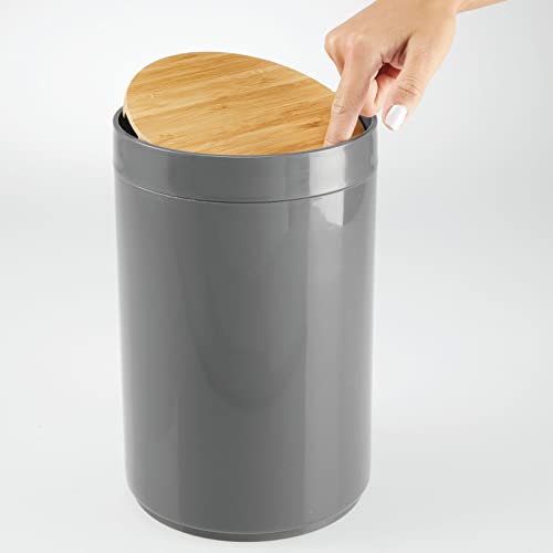 Image of mDesign Plastic Round Trash Can Small Wastebasket - Garbage Bin Container with Swing-Close Lid - Bathroom Garbage Basket - Holds Waste, Recycling - 1.3 Gallon - Basa Collection - Charcoal Gray /Natural