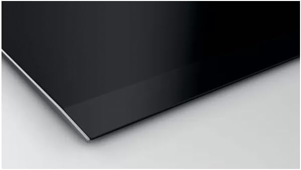 Close-up side view of the sleek black ceramic surface of the Siemens induction cooktop, showing its smooth finish.