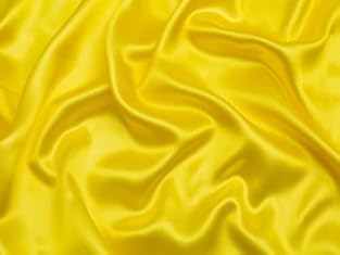 Satin is a weave known for its shiny surface on one side and a duller finish on the other. Its sheen ranges from subtle to high gloss. Lightweight satins like charmeuse offer a soft drape, while heavier types like duchess and mikado provide structure...