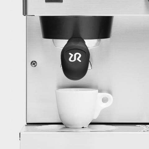 Close-up of espresso machine group head with a cup underneath