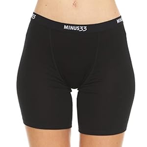 A woman wearing black Merino wool boyshorts with the Minus33 logo on the waistband.