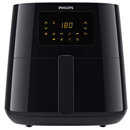 Philips Essential Airfryer XL HD9270/91 in matte black finish on a kitchen counter, the single drawer basket pulled forward showing the unique Starfish Design at the bottom of the basket lifting golden-crispy french fries up off the heating element while hot air circulates underneath, digital display on the front showing the cooking timer and temperature, the Philips logo at the top edge — Philips invented the modern air fryer in 2010 and the Rapid Air Technology is the foundational design that all subsequent air fryer brands copied
