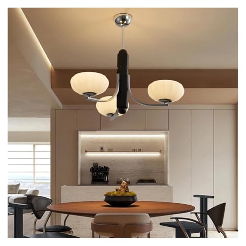 Chambre luxe illuminée par une suspension en bois style antique
