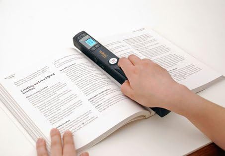 Person scanning a book with the Magic Wand Scanner