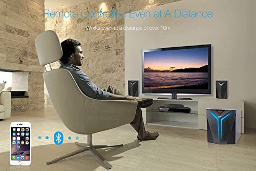 User operating the speaker system with remote control from a distance