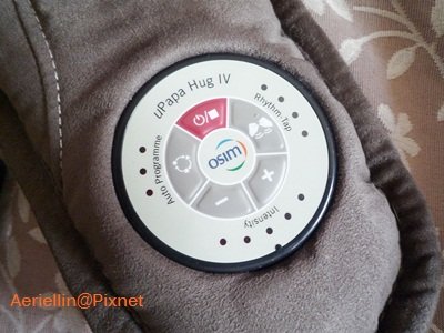 Karibu-up view of the OSIM uPapa Hug IV control panel, featuring buttons for power, auto program, rhythm-tap, and intensity adjustment (+/-).