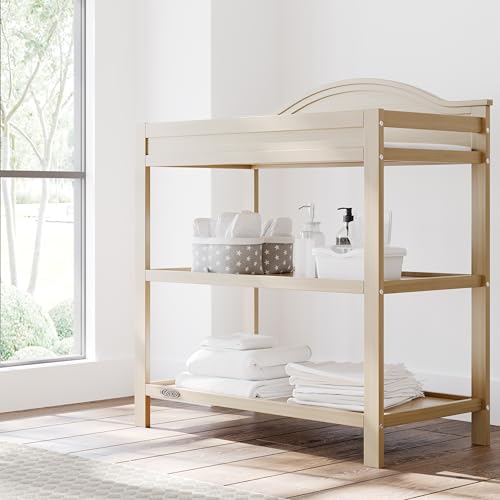 Image of Graco Story Changing Table with Water-Resistant Pad - GREENGUARD Gold Certified Baby Changing Station with Safety Strap, 2 Open Shelves, and a Nursery Must-Have Design (Driftwood)