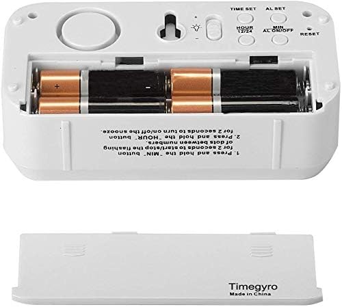 Rear view of the Timegyro Digital Alarm Clock with the battery compartment open, showing four AA batteries inserted.