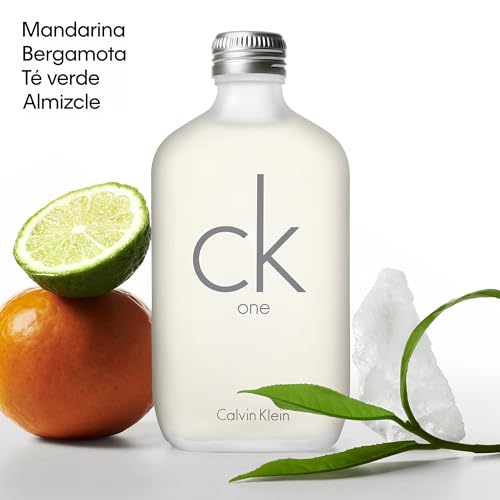 Frasco de CK One de Calvin Klein acompañado de elementos naturales: mandarina, bergamota, té verde y almizcle.