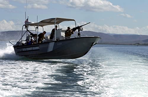 US Coast Guard (USCG) Personnel to Port Security Unit Detachment Delta (PSUDD) conduct a high-speed patrol aboard A 25-foot Transportable Port Security Boat (TPSB) - 12 Inch by 18 Inch Laminated Poster - Bright Colors And Vivid Imagery
