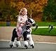 Ponnie Reitpferd mit Rollen Domino S (3-6 Jahre), Spielpferd zum Reiten mit Abnehmbarer Rosa Sattel und Halfter mit Zaumzeugund Kämmbare Mähne und Schwanz, Plüschpferd zum Reiten für Kinder