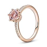 Er trägt einen glitzernden rosafarbenen Kristall in Krappenfassung in Form einer Krone und klare Cubic Zirkonia oben auf dem Ring sowie seitlich an der Fassung der Krone