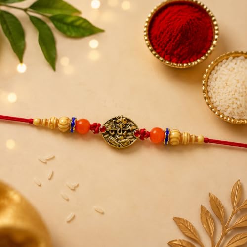 Image of DeoDap Rakhi with Chocolate for Brother - Golden Color Round Ganesha Style Rakhi with Pistachio Cream Cigar Rolls, Silver Color Coin, Greeting Card & Tilak Set - Raksha Bandhan Pack (k1 1130 CG-P)