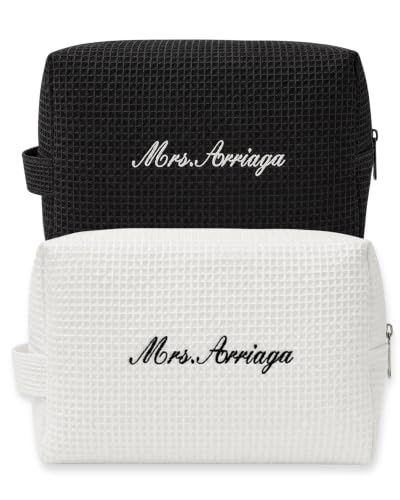 a canvas makeup pouch with a three-letter monogram embroidered near the zipper