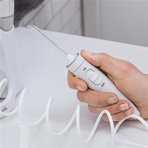 Hand holding Waterpik Ultra Plus handle with on/off switch