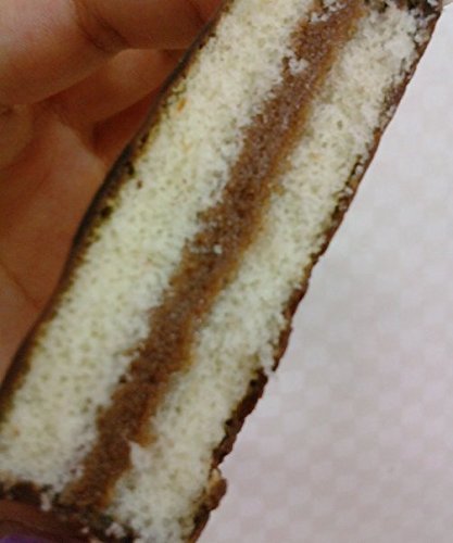 A close-up view of the internal layers of a Haitai Oh Yes! cake, showing the cake and creamy filling.