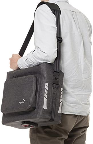 Person placing items into the open Tern DryGoodsBag.