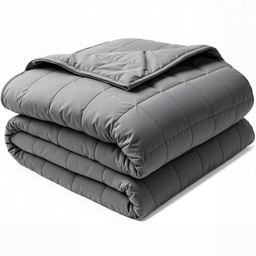 gray weighted blanket folded on a bed with visible grid stitching
