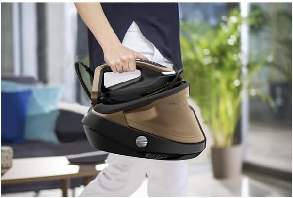 User carrying the Calor GV9820C0 steam generator iron by its handle