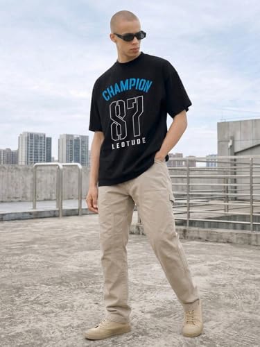 Image of LEOTUDE Men's Street Style Graphic T-Shirt | Athletic Typography Print | Oversized | Round Neck | Graphic Print | Baggy Fit | Drop Shoulder | Casual Tee (Color : Black)