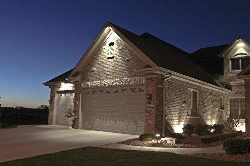 Outdoor night scene showing a house illuminated by floodlights, demonstrating the KOR LED PAR38 bulbs in an outdoor application.