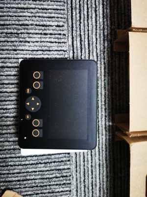 Front view of the IFM CR0452 device, showing a dark display area surrounded by several circular control buttons.