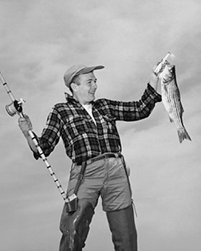 Mid adult man holding dead fish and fishing pole Poster Print (18 x 24) Home & Kitchen
