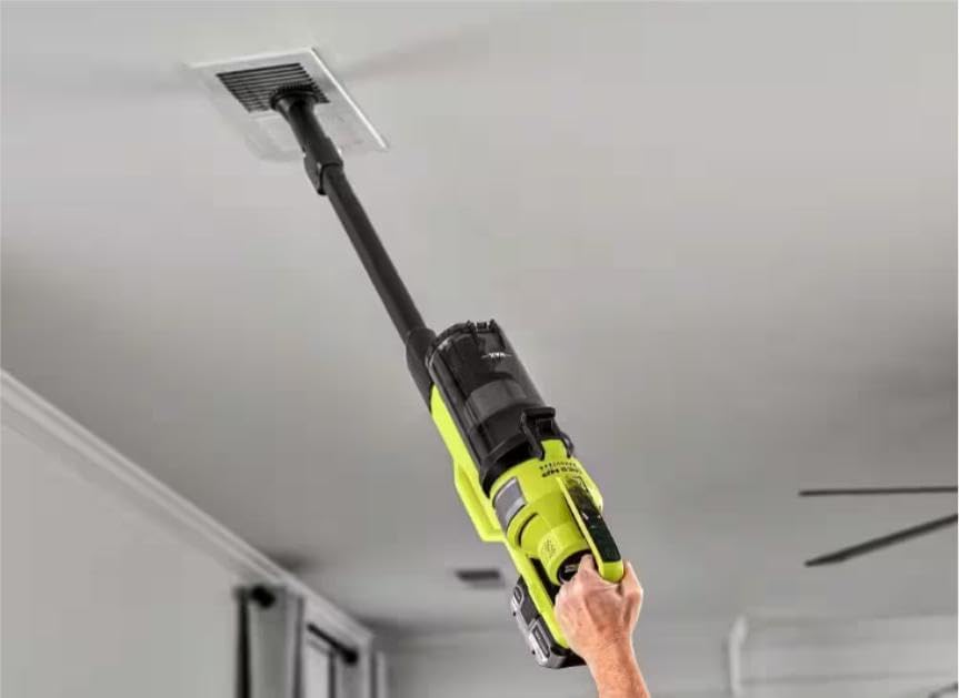 Person using the CUSHYBITE HP 18V Cordless Pet Stick Vacuum in handheld mode to clean a ceiling vent