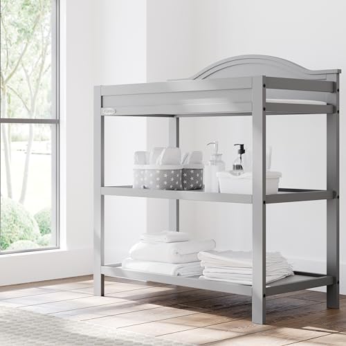 Image of Graco Story Changing Table with Water-Resistant Pad - GREENGUARD Gold Certified Baby Changing Station with Safety Strap, 2 Open Shelves, and a Nursery Must-Have Design (Pebble Gray)