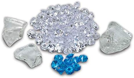 A pile of clear ice media glass crystals, with some blue accent crystals and larger clear glass pieces.