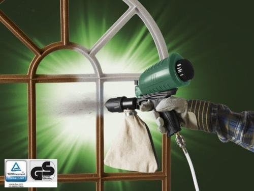 Sandblasting gun in use on a window frame